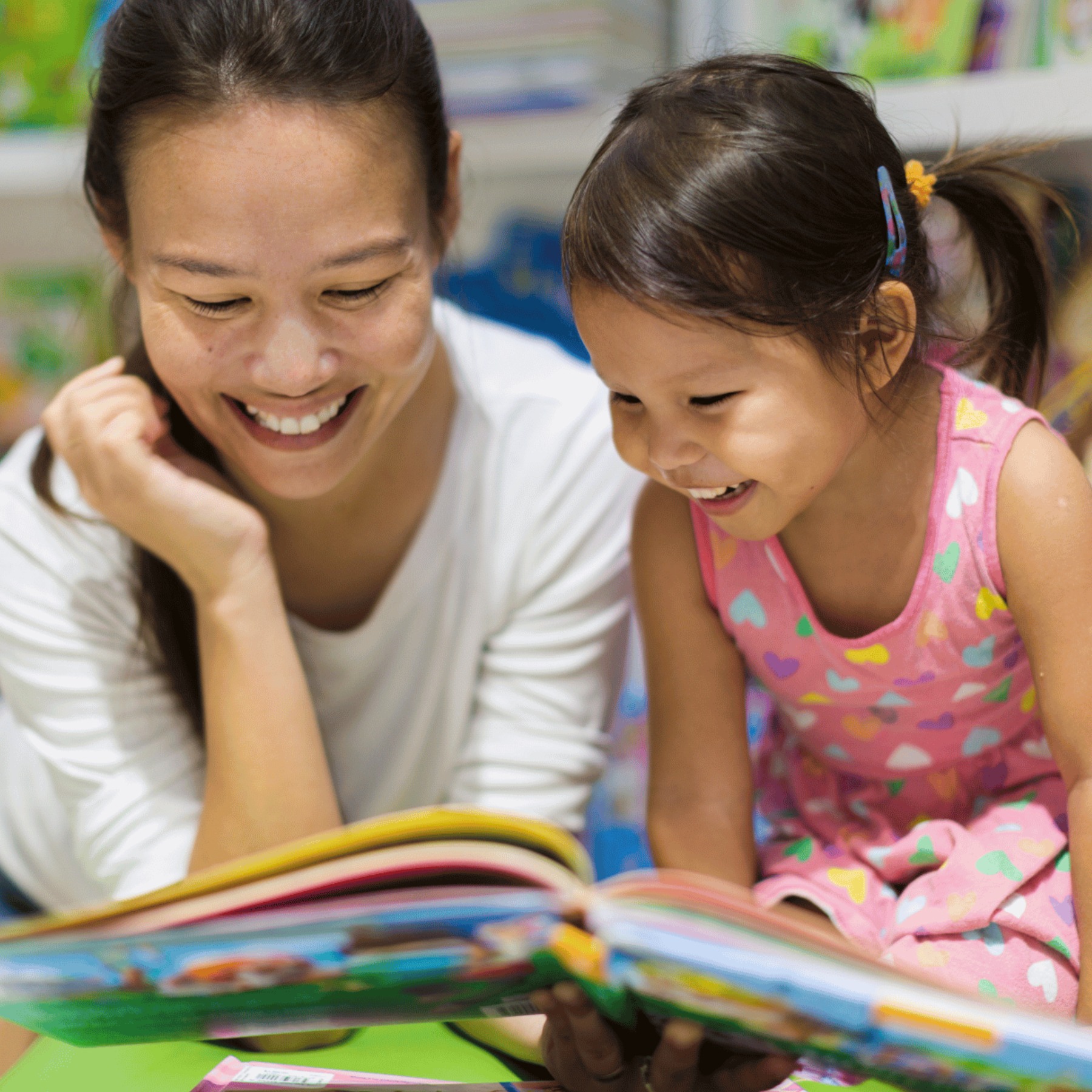 mom reading book to girl 